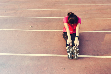 Young woman runner warm up outdoorの写真素材