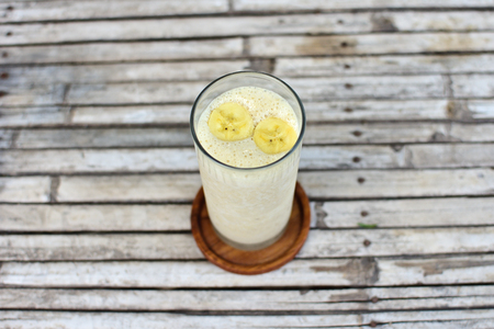 Homemade useful Banana Smoothie in glass for healthy breakfastの写真素材