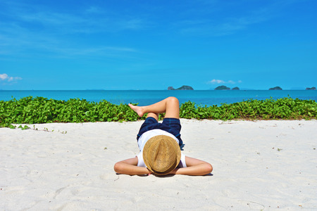 A young woman is relaxing on a Samui island tropical beach in Thailandの写真素材