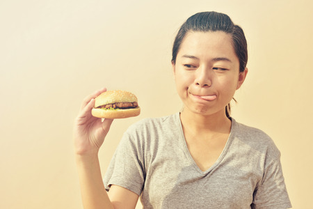 Women look at hamburgers in her hands ready to eat.の写真素材