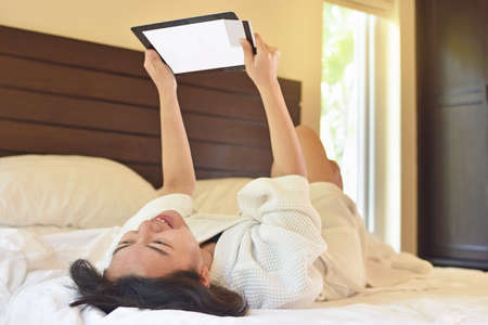 Shopper woman buying online on the smart tablet in the room
