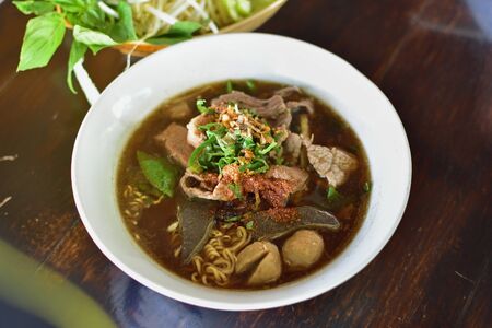 A bowl of Thai style beef noodle soup.