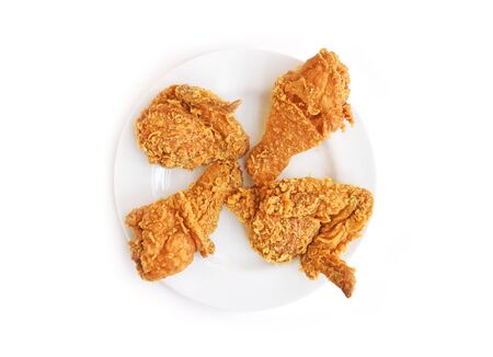 Top view fried chicken in white plate isolated on white backgroundの写真素材