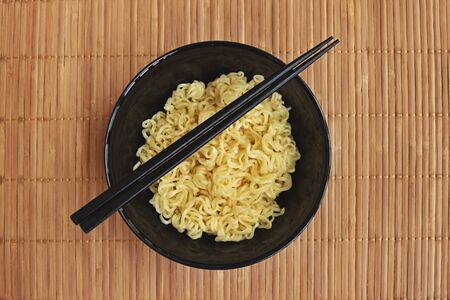 A Bowl of instant noodles on wooden backgroundの写真素材