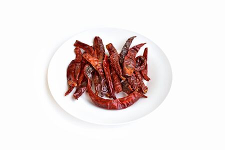 A plate of red dried chili on a white background.の写真素材