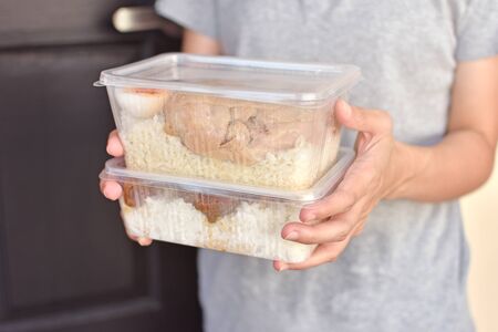 Lunch box with food in the hands.の写真素材