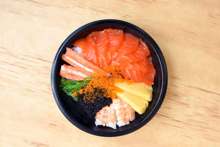 Japanese Rice with Salmon and Tobiko on wooden backgroundの写真素材
