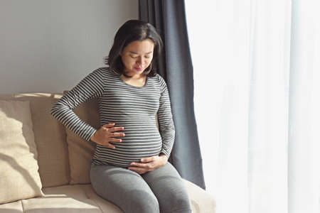 Pregnant woman resting on the couch.