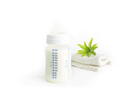 Baby bottle with diaper on white backgroundの写真素材