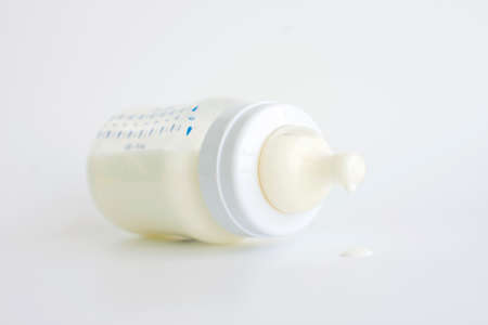 close-up of milk drops on a baby feeding bottle teat