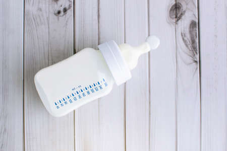 Milk bottle on wooden table topviewの写真素材