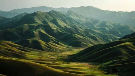 Beautiful mountain landscape with rolling green hills under soft morning sunlightの素材