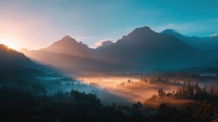 Experience the tranquility of a stunning sunrise illuminating majestic mountains over a misty valley. Perfect for nature lovers and travelers.の素材