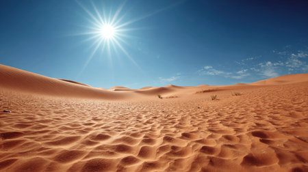 This impressive desert landscape showcases soft sand dunes beneath a brilliant sun and clear blue sky, evoking feelings of adventure and tranquility.の素材