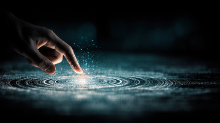 A captivating image of a hand reaching out to touch a glowing surface surrounded by spirals of light and shimmering particles, evoking a sense of connection and exploration.の素材