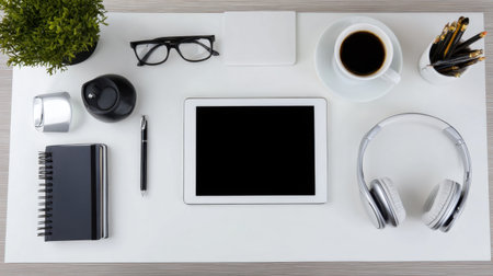 Explore a modern workspace featuring a tablet, coffee cup, and various accessories, all arranged on a minimalist desk for productivity and inspiration.の素材