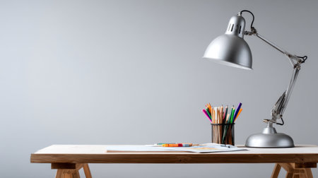 A modern workspace featuring a stylish desk lamp and colorful art supplies arranged on a clean wooden table, perfect for creativity and productivity.の素材