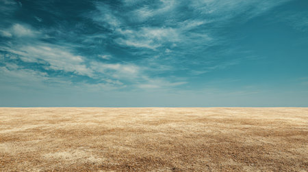 Experience the beauty of a vast barren grassland under a stunning blue sky adorned with soft clouds. This serene landscape captures the essence of tranquility and open space.の素材