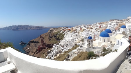 Santorini cliffside village with blue domes, whitewashed buildings, and Aegean Sea belowの素材
