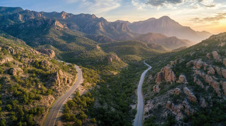 Scenic road winding through mountains, ideal for an epic travel adventureの素材