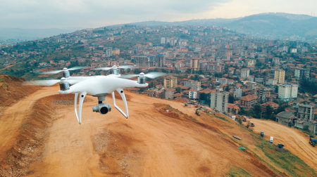 Drone navigating construction site capturing panoramic footage of overall projectの素材