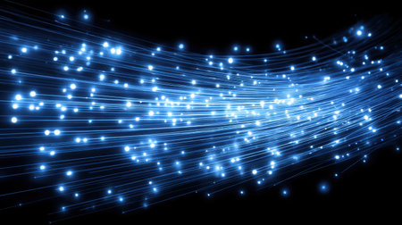 Stunning abstract image featuring bright blue light trails with glowing particles on a black background, perfect for digital art projects and design needs.の素材