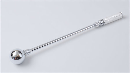 This image showcases a sleek stainless steel tool featuring a spherical head and textured grip. Ideal for showcasing modern design and utility.の素材