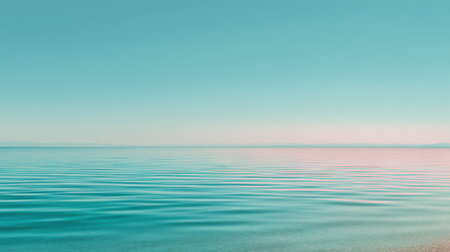 A breathtaking view of calm ocean waters under a soft blue sky, showcasing gentle waves that reflect tranquility in a peaceful coastal landscape. Perfect for relaxation.の素材