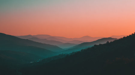 A breathtaking view of a mountain landscape during sunset, showcasing soft hues of pink and orange blending with cool blue tones, evoking peace and tranquility.の素材