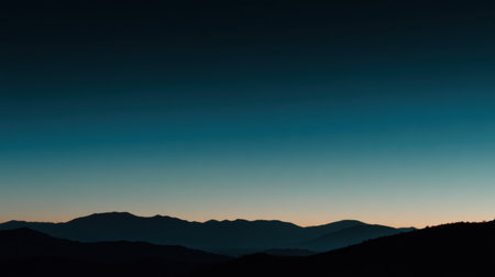 A breathtaking silhouette of mountains set against a stunning gradient sunset sky, capturing the essence of tranquility and the beauty of nature in a serene landscape.の素材