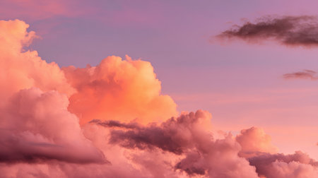 A stunning display of soft pink and orange clouds during sunset, creating a peaceful atmosphere perfect for relaxation and nature appreciation in any setting.の素材
