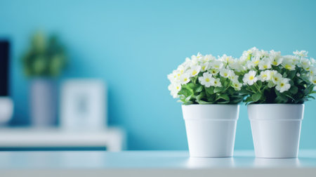 Beautiful potted flowers create a cheerful atmosphere in a modern home setting, featuring a soft focus background that enhances indoor tranquility and style.の素材