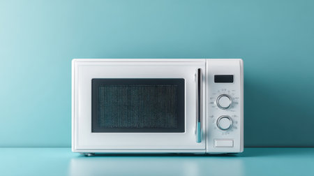A sleek, modern white microwave oven sits on a turquoise background, serving as a stylish addition to any kitchen. Perfect for food preparation and everyday cooking needs.の素材