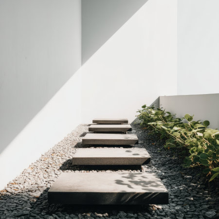 A calm and modern outdoor pathway featuring concrete slabs bordered by greenery, creating a serene and minimalist landscape for relaxation and contemplation.の素材