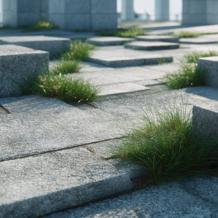 This image captures a serene urban landscape showcasing natural elements, featuring stones and green grass thriving between pavement blocks, ideal for peaceful settings.の素材