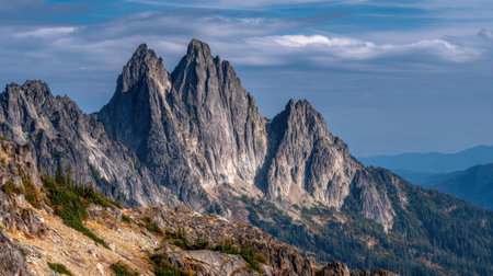Stunning view of towering mountain peaks under a bright sky, showcasing unique rock formations and surrounding lush forest. Perfect for outdoor and nature enthusiasts.の素材