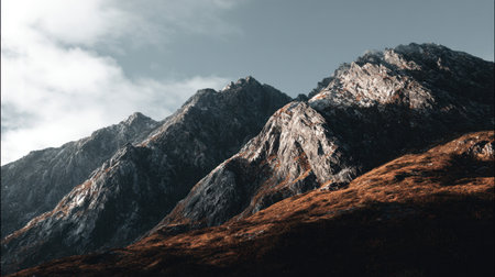 Explore the stunning beauty of a rugged mountain range with dramatic peaks and serene skies, showcasing the raw essence of the outdoors and nature's magnificence.の素材