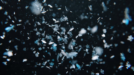 This stunning image captures the elegance of falling snowflakes against a dark background, showcasing their intricate patterns and the beauty of winter's chill.の素材