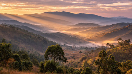 A breathtaking scene depicting a vibrant sunrise over a misty mountain valley, where rays of light illuminate the natural landscape, creating a serene atmosphere.の素材