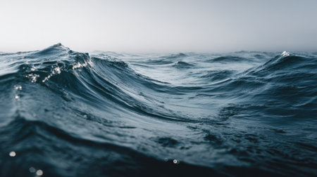A tranquil view of gentle ocean waves beneath a soft gray sky evokes feelings of calm and serenity, making it an ideal backdrop for relaxation or meditation.の素材