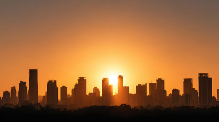 A stunning urban skyline silhouette featuring tall skyscrapers during a captivating sunset offers a serene and vibrant atmosphere, perfect for cityscape lovers.の素材