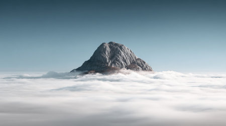 A stunning view of a mountain peak emerging from soft white clouds under a clear sky, depicting nature's serene beauty and the majesty of untouched landscapes.の素材