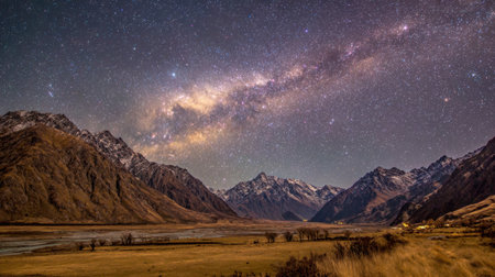 A stunning nightscape showcasing the Milky Way galaxy illuminated over majestic snow-capped mountains, reflecting tranquility in a remote wilderness setting.の素材