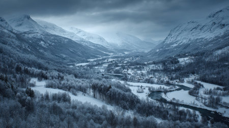 A breathtaking winter landscape showcasing a valley blanketed in snow, flanked by majestic mountains and a winding river beneath a moody sky. Perfect for nature lovers.の素材