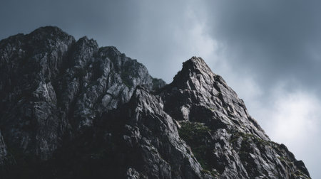 Experience the awe-inspiring beauty of rocky mountain peaks against a dramatic sky, showcasing nature's raw power and stunning landscapes in this breathtaking image.の素材