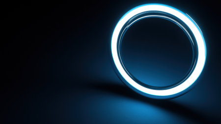 This image features a striking blue glowing ring with a luminous edge, set against a dark background, perfect for modern design projects and creative applications.の素材
