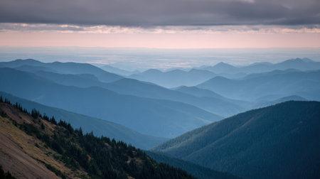 Explore a breathtaking mountain landscape showcasing soft blues and gentle slopes, enveloped in a peaceful atmosphere with a cloudy sky, perfect for nature enthusiasts.の素材