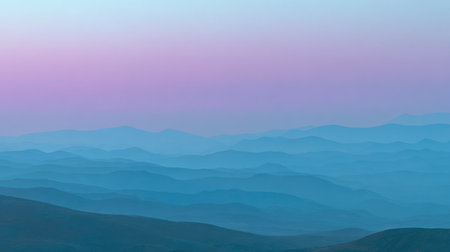 A breathtaking view of layered mountains captured at dusk, showcasing beautiful blue and purple hues that evoke a sense of calm and serenity in nature.の素材