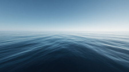 A captivating view of a calm ocean under an expansive blue sky highlights the peacefulness of nature. Ideal for themes of relaxation and tranquility.の素材