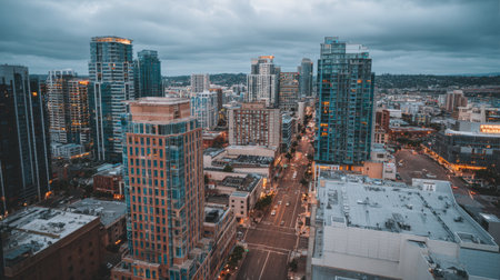 Captivating aerial shot of a vibrant cityscape at dusk, showcasing modern architecture against a dramatic cloudy sky, evoking a sense of urban life and design.の素材